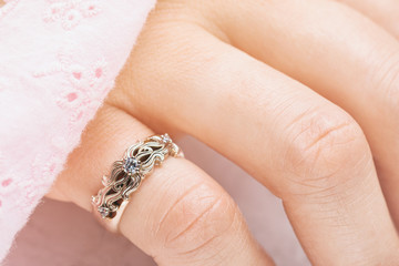 White gold ring with diamond on a female hand