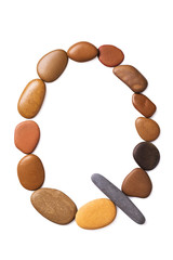 Letter Q made of marine small pebbles, top view. Alphabet made of stones Isolated on a white background