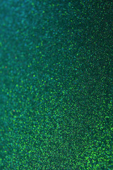 Emerald green shiny defocused lights bokeh background.copy space texture. rain drops