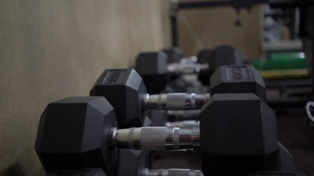 man takes dumbbells in his hands