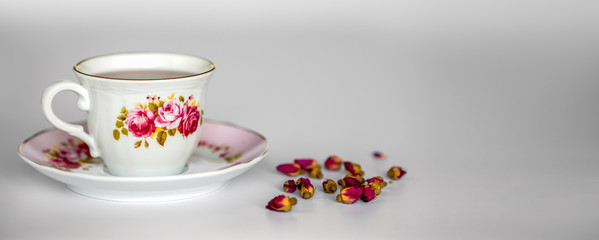 A cup of tea with dried roses