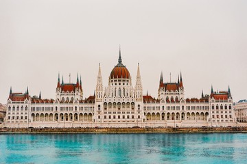 Fototapeta premium View to Hungarian Parliament Danube River. Beautiful scene of ancient gothic architecture.