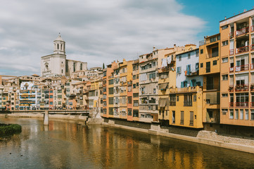 Fototapeta na wymiar Landscape of Girona city, Catalonia, Spain. View on St. Agusti Bridge and Saint Mary Cathedral