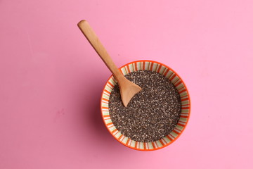 Bowl with chia seeds and wooden spoon