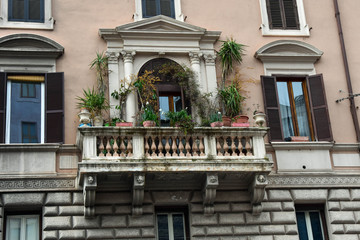 Antique balcony with many flowers in Rome