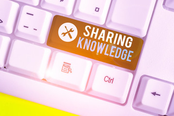 Writing note showing Sharing Knowledge. Business concept for knowledge is exchanged among showing...