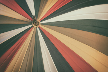 Abstract vintage background of old multicolored umbrella with texture