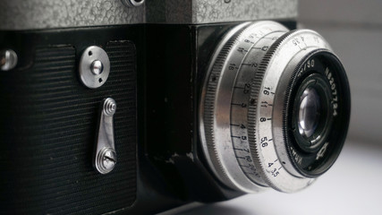 The old Soviet 35mm SLR camera. Retro photo technology on the white background. 