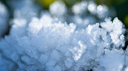 Fototapeta na wymiar Fresh winter snow closeup of crystals. Shallow depth of field. Winter background