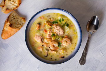Seafood chowder with salmon, shrimps, crabmeat and mussels. View from above, top view