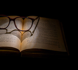 Pair of Glasses Sitting on Old Open Book  Forming a Heart