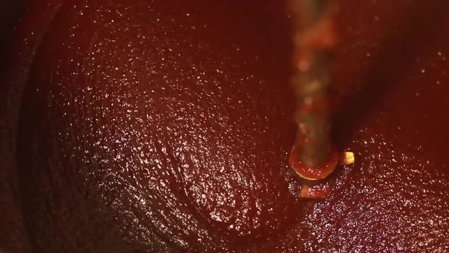 Homemade quince paste cooking in machine, membrillo production