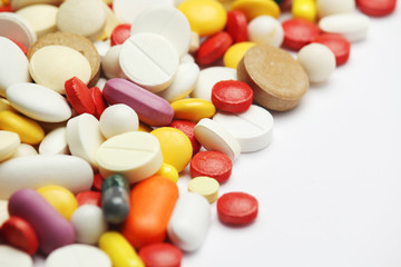 Different colorful tablets at white background	