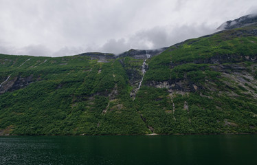 Little waterfall. Views inside the Geiranger fjord taken by the ferry hellesylt geiranger. July 2019