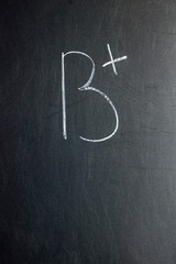 Grade B + written on chalk board