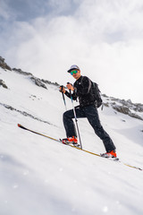 The skituring man, backcountry skiing in fresh powder snow.