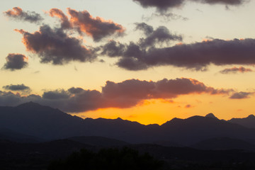 Naklejka na ściany i meble beautiful sunset sky over mountains on Sardinia