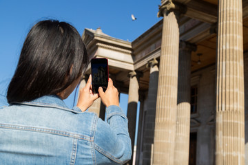Young woman at the municipal theater of Quetzaltenango taking a picture - girl taking a picture at the theater of Xela Guatemala