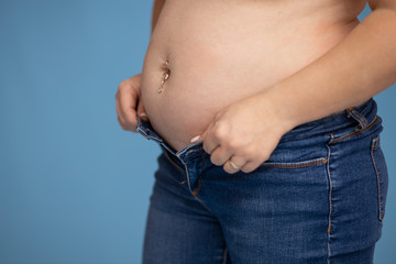 Thick belly of a woman 30-33 years old, does not fit in jeans