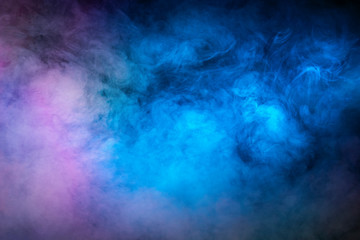 Fototapeta na wymiar Backlit smoke abstract texture in pink blue on black background.