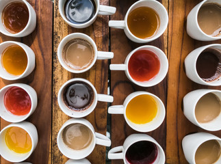 Tasting of different types of coffee and natural teas (ginger, vainilla) on a wooden background in Bali, Indonesia