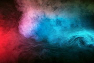 Backlit smoke abstract texture in red blue white on black background.