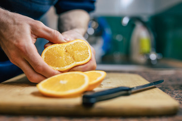 Close Up Of Man's Hands Pressing Orange
