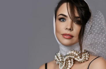 Portrait of young beautiful brunette woman in white stylish hood and accessories