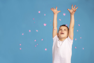 Fototapeta na wymiar happy birthday boy with confetti on a colored blue background