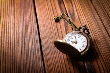 pocket watch on a wooden background