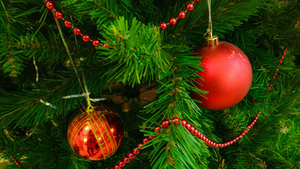 Artificial Christmas tree, decorated with red balls and red beads
