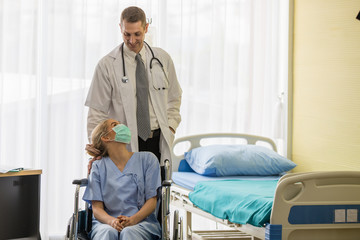 The male doctor and a female patient in a wheelchair