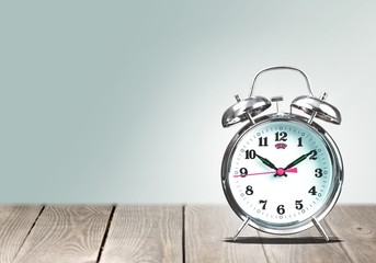 Retro alarm clock on wooden table