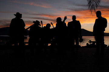 Fototapeta na wymiar Silhouette of Mariachi players in Lake Chapala, Mexico