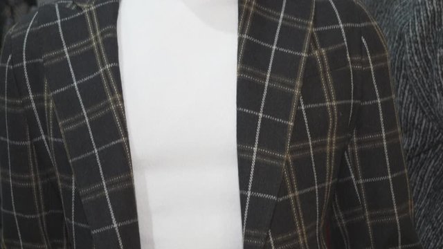 A windowpane check blazer on a maneken.