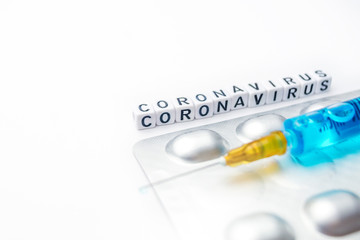 Novel coronavirus - 2019-nCoV concept, syringe and pills isolated on white