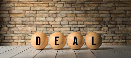 wooden balls with the word DEAL in front of a brick wall