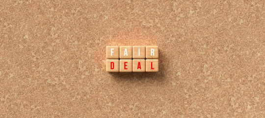 cubes with the words FAIR DEAL on cork background