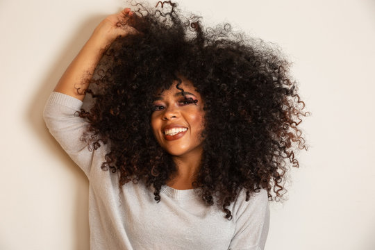 Beauty portrait of african american woman with afro hairstyle and glamour makeup. Brazilian woman. Mixed race. Curly hair. Hair style. White background.