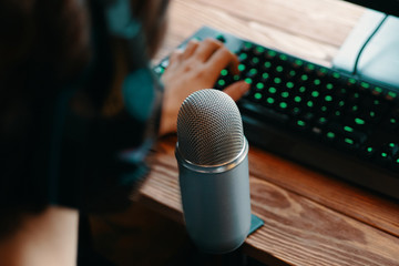 Podcast studio. Microphone with keyboard in broadcast atelier. Man in monitor headphones