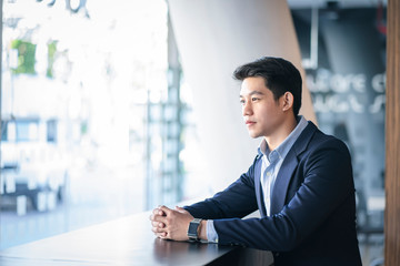 Portrait of casual young  entrepreneur businessman working in modern work station.