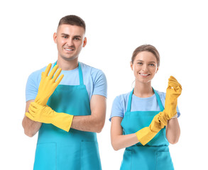 Portrait of janitors putting on rubber gloves against white background