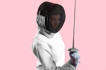 Young female fencer on color background