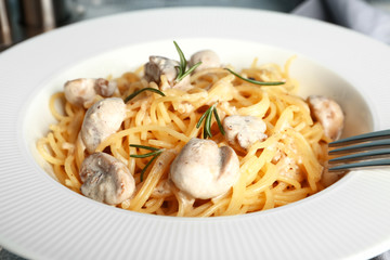 Plate with tasty pasta and mushrooms, closeup