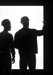 Silhouette of male engineers on white background