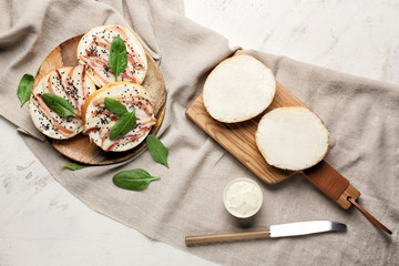 Fresh buns with tasty cream cheese and bacon on table