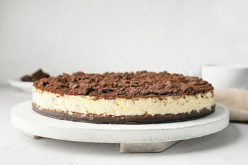 Tasty chocolate cheesecake on white table