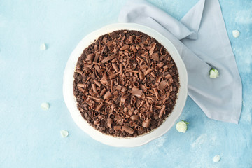 Tasty chocolate cheesecake on color background