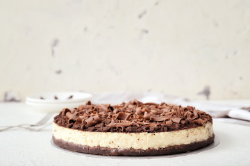 Tasty chocolate cheesecake on white table