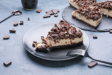 Plate with piece of tasty chocolate cheesecake on table